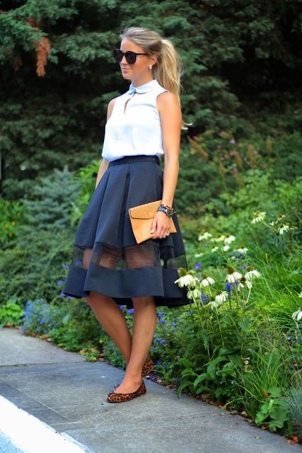 With A-line skirt, yellow clutch and leopard flats