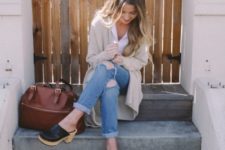 With beige cardigan, distressed jeans and marsala bag