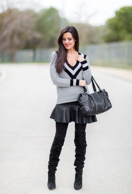 With black leather skirt, black bag and over the knee boots