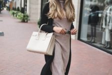 With black long cardigan, white bag and black ankle boots
