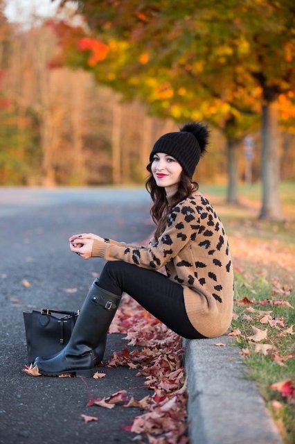With black pants, pom pom hat and black high boots