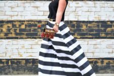 With black shirt, black high heels and printed small clutch