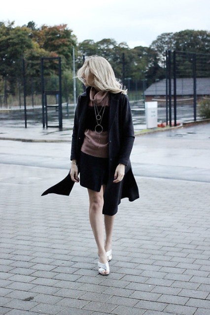With black skirt, shirt and black coat