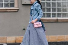 With denim shirt and pale pink small bag