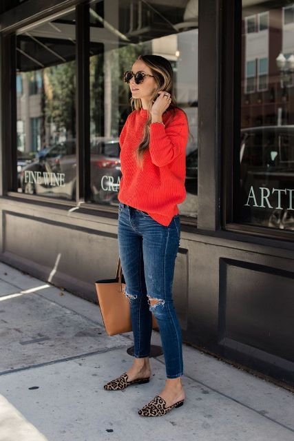 With distressed jeans, brown tote and red sweater