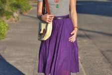 With gray t-shirt, necklace, purple skirt and two colored bag