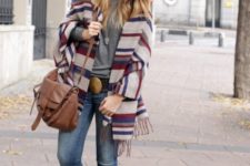With gray t-shirt, skinny jeans, brown bag and fringe boots