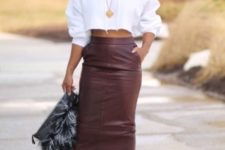 With high-waisted leather midi skirt, fur clutch and black sandals