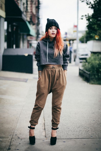With high-waisted pants, hat and platform shoes