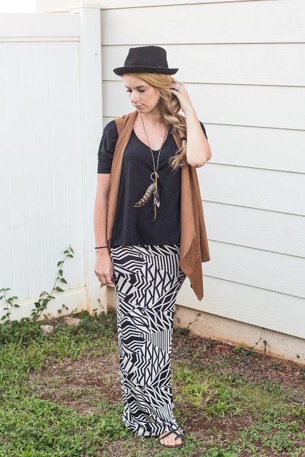 With loose shirt, printed maxi skirt and black hat