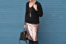With metallic skirt, black tights, black ankle boots and black bag