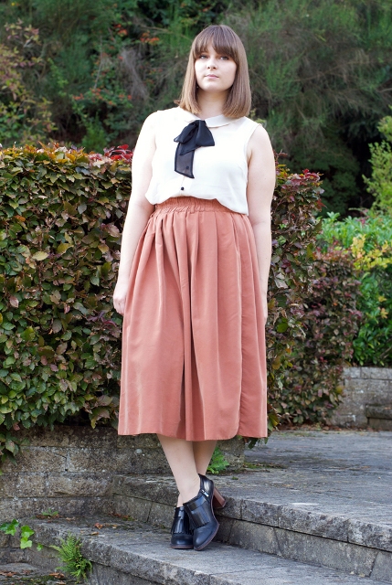 With midi skirt and black ankle boots
