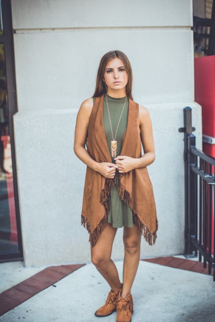 With olive green dress and boots