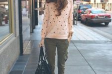 With olive green pants, flats and big bag