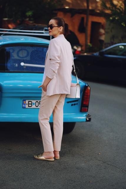 With pale pink blazer, trousers and bag