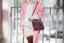 With pale pink coat, printed skirt, marsala bag and high boots