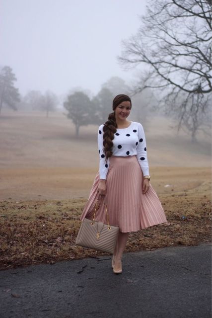 With pale pink pleated midi skirt, beige leather bag and pumps
