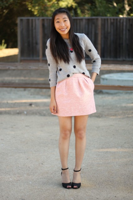 With pink mini skirt and black ankle strap shoes
