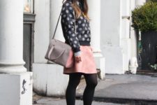 With pink skirt, embellished boots and gray and pink bag