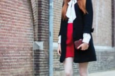 With red high-waisted skirt, black coat, clutch and black high boots