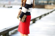 With red knee-length skirt, leopard clutch and leopard pumps