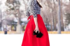 With red midi skirt, black clutch and black high heels