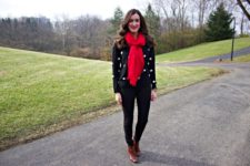 With red oversized scarf, black pants and brown ankle boots