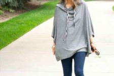 With skinny jeans and gray ankle boots