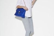 With white button down shirt, gray trousers and blue bag