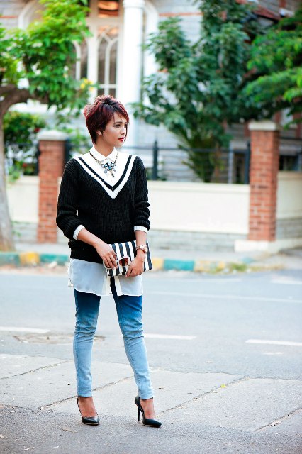With white shirt, jeans, pumps and striped clutch