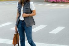 With white t-shirt, gray vest, crop jeans and brown bag