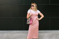 With white t-shirt, printed bag and pale pink midi dress