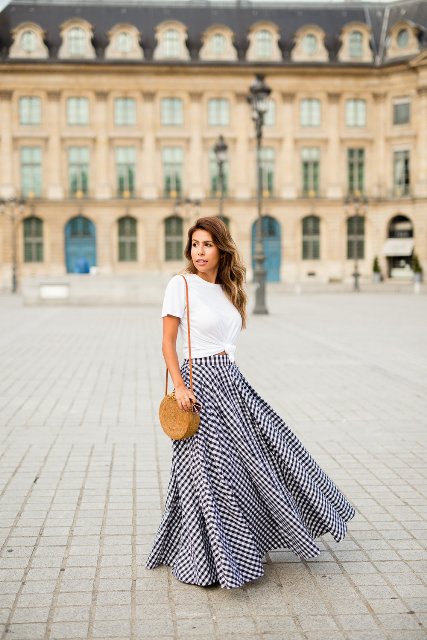 With white t-shirt, round straw bag and heels