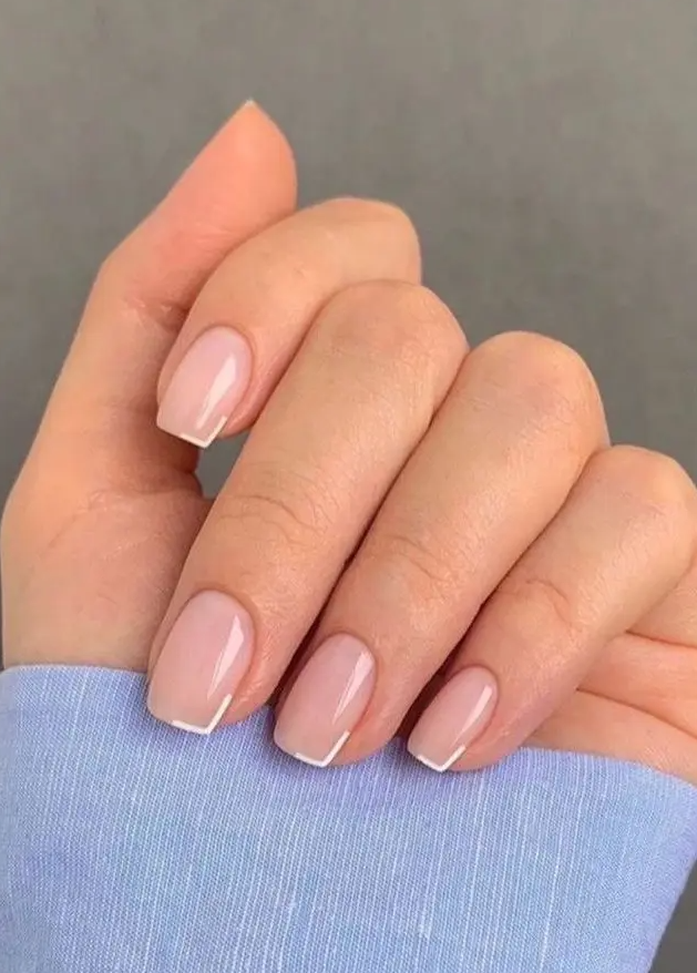 a catchy modern French manicure with square nails and micro white corners as a fresh alternative to usual French tips