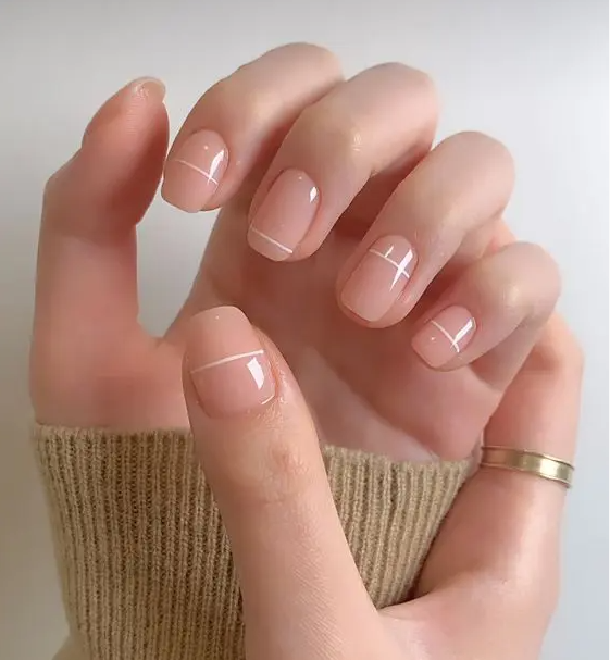 a classy nude square manicure with white stripes is a cool and catchy idea for a modern look
