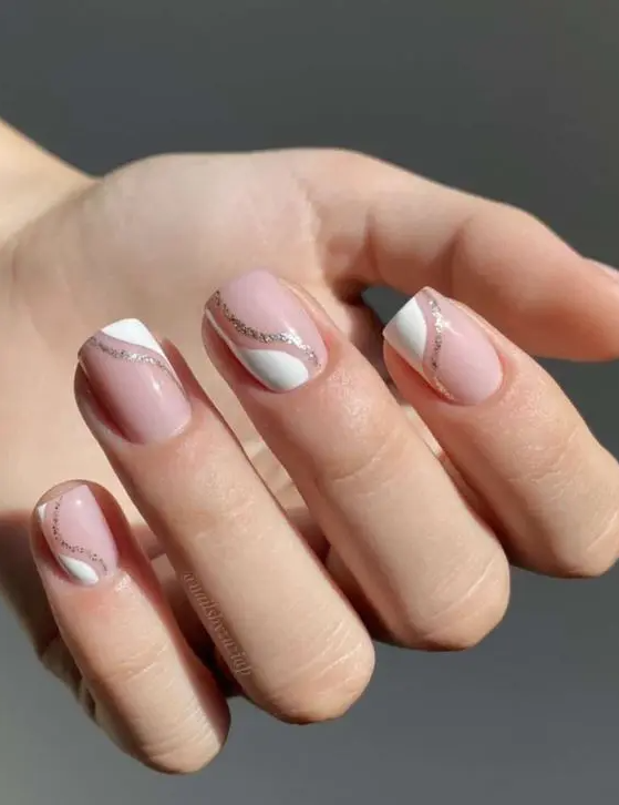 a fresh and glam take on French manicure done on short square nails, with white and silver glitter waves is wow