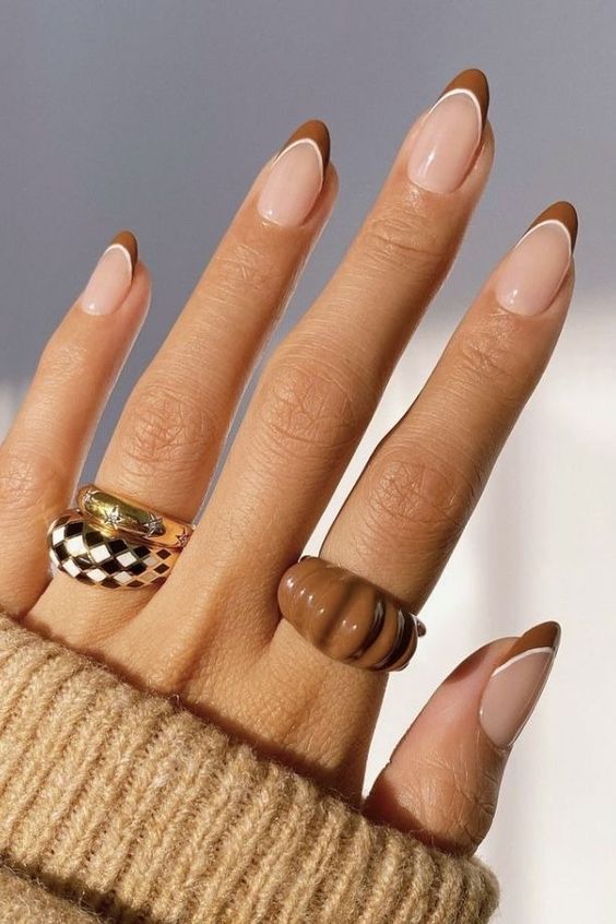 a lovely fall-inspired French manicure with brown and white tips is a pretty idea for the season