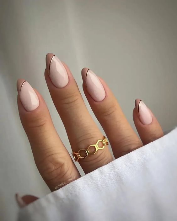 beautiful blush and beige French nails with copper stripes are a cool and creative idea for wearing now