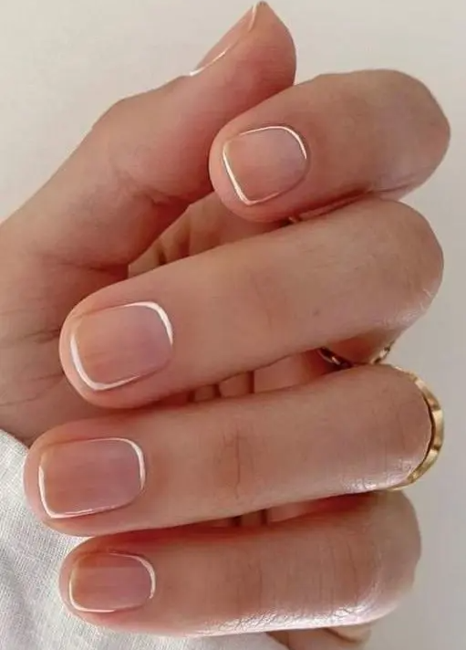 short square nude nails with white touches are a cool solution if you like French nails but not traditional ones