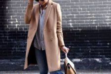 05 blue jeans, a striped shirt, white sneakers, a tan bag and a camel coat