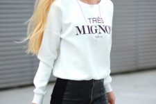 06 a white printed sweatshirt, a black mini skirt with a slit and a black bag for a sexy feel