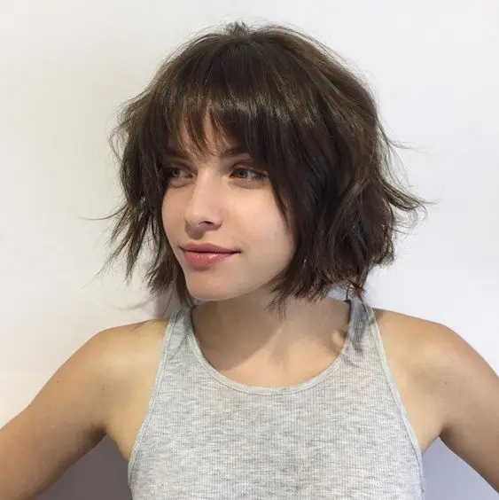 a choppy short bob wiht bangs is a great modenr option, spruce it up with messy waves