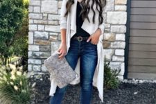 07 blue jeans, a black top, an off-white cardigan and booties plus a matching clutch