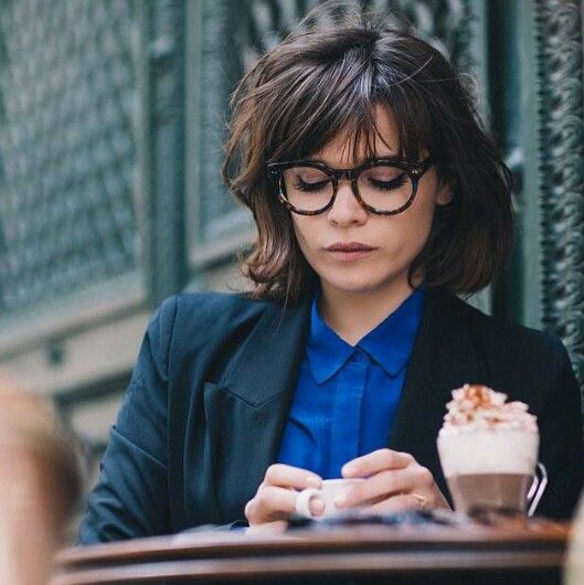 a French chic bob with layers and bangs plus glasses for a chic nerdy look