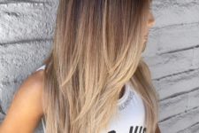 10 a long cascading layered haircut with a brown to blonde ombre to make a statement