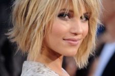 11 a cool short layered shaggy haircut with bangs and a dark root for a dimensional look