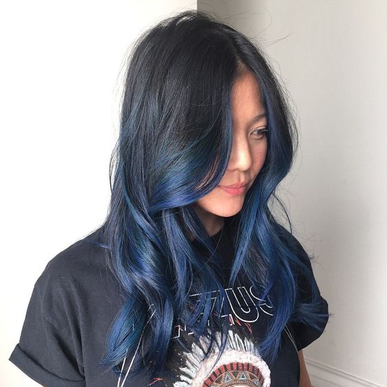bold black to blue ombre hair on a long layered haircut for a statement