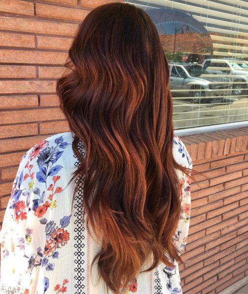 long auburn hair with red highlights and loose waves for a bright look