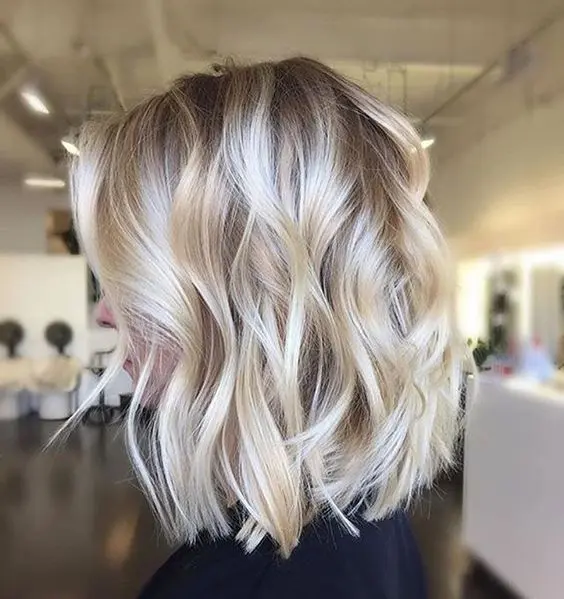 soft blonde balayage with a darker toot and silver touches plus messy waves is an edgy option