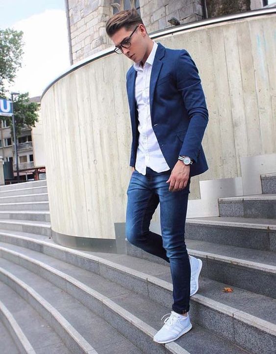 navy jeans, a white shirt, a navy blazer and light blue sneakers for a smart casual look